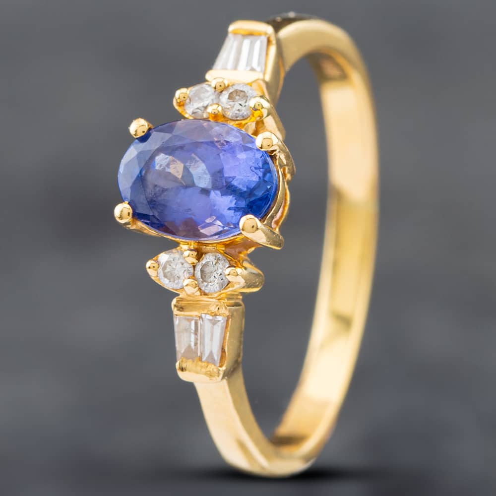 Product photograph of Pre-owned 18ct Yellow Gold Oval Cut Tanzanite Amp Diamond Seven Stone Ring 41481447 from The Jewel Hut