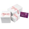 White wrapping with a pink satin bow