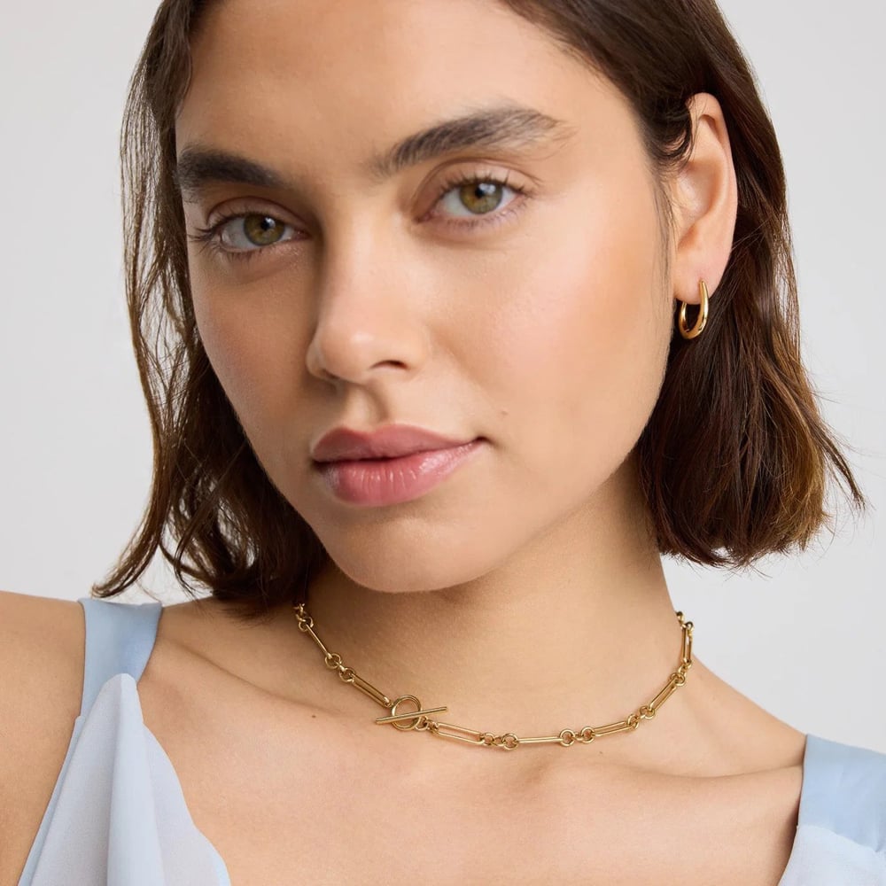 D.Louise Yellow Gold Tone Plated Stainless Steel Tapered Oval Hoop Earrings NAE-28