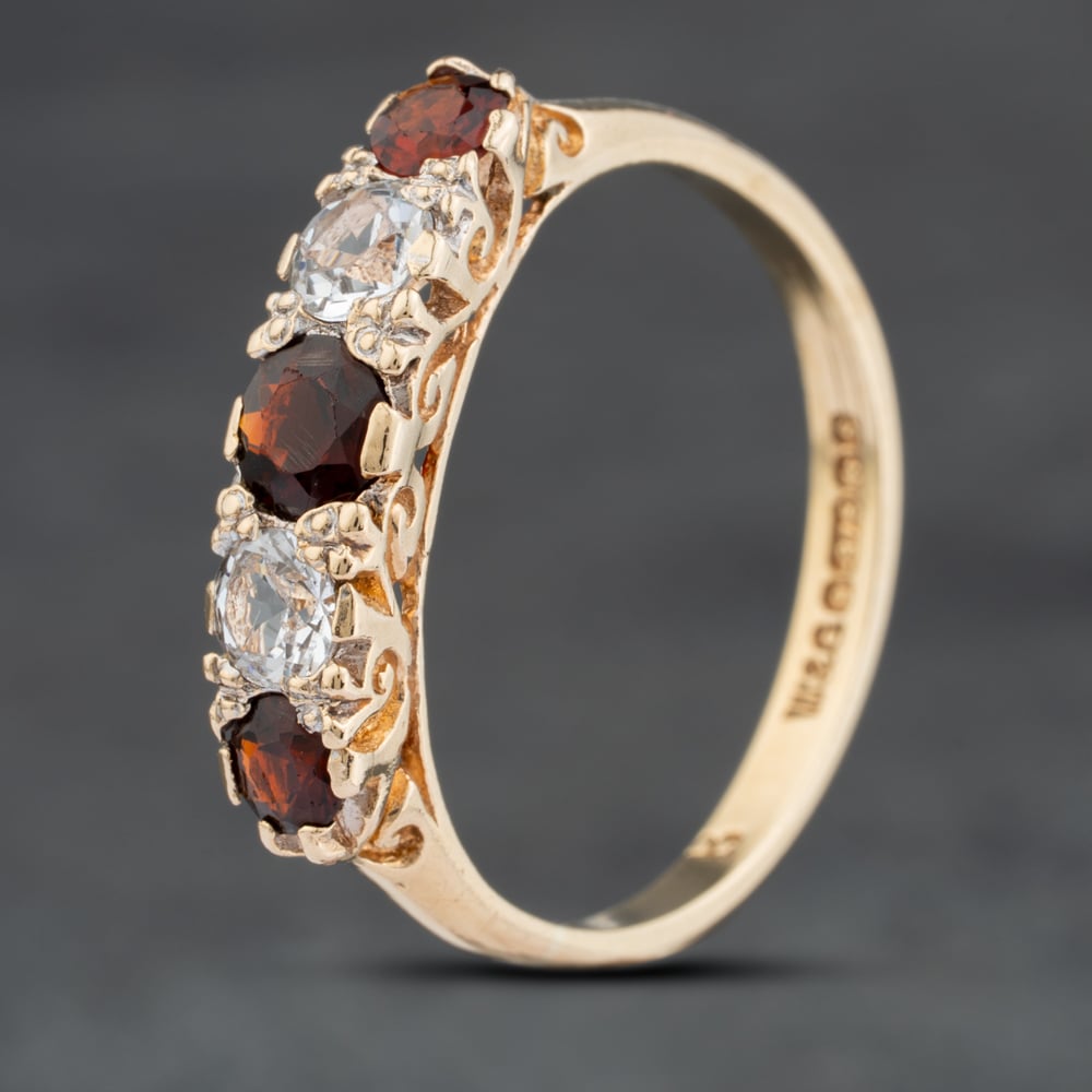 Click to view product details and reviews for Pre Owned 9ct Yellow Gold Garnet And White Spinel Five Stone Ring 41104029.