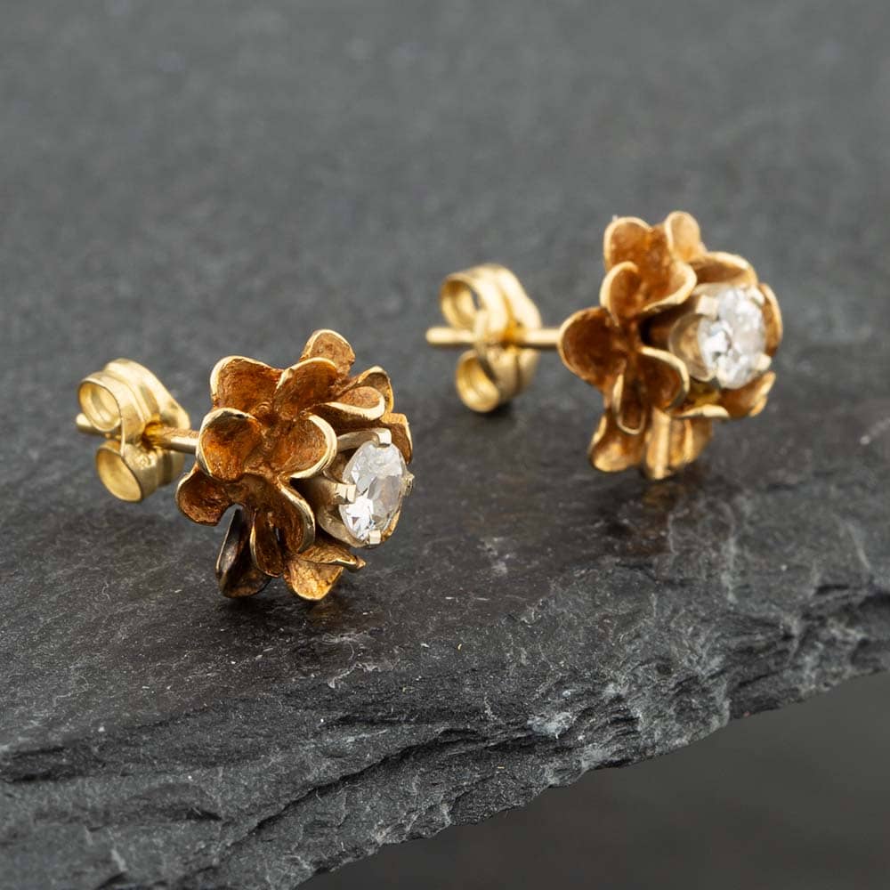Product photograph of Pre-owned 9ct Yellow Gold Brilliant Cut Diamond Single Stone Flower Stud Earrings 41171285 from The Jewel Hut