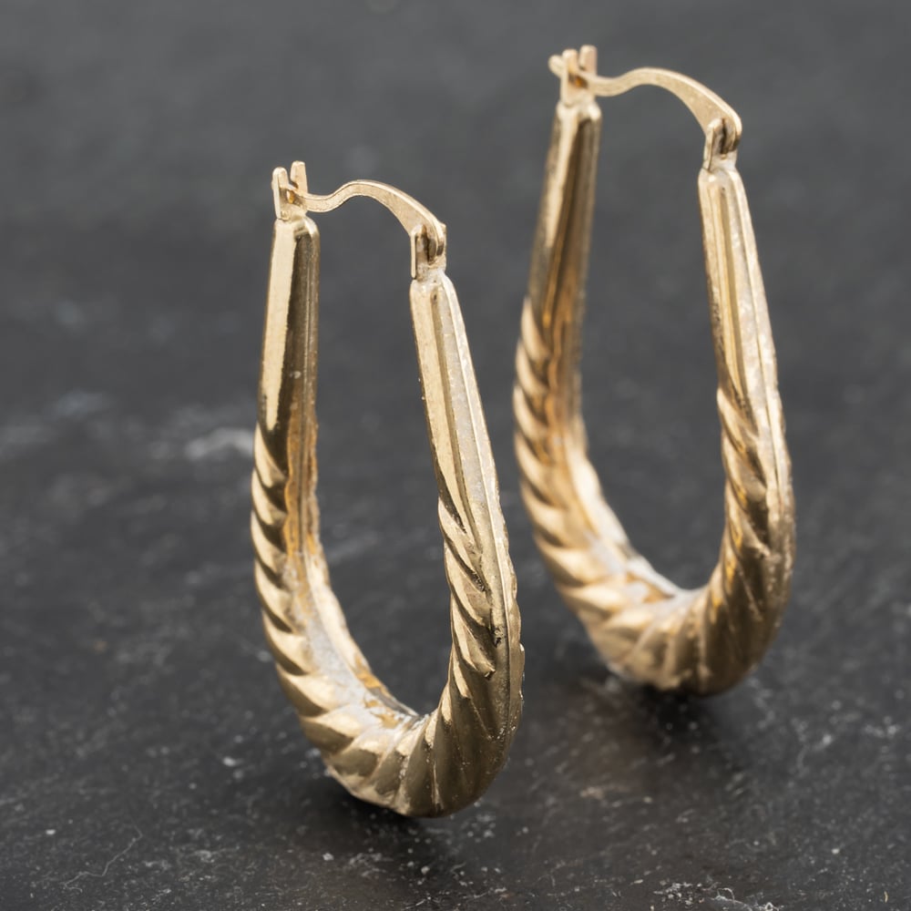 Click to view product details and reviews for Pre Owned Yellow Gold 27mm Oval Patterned Creole Earrings 41173462.