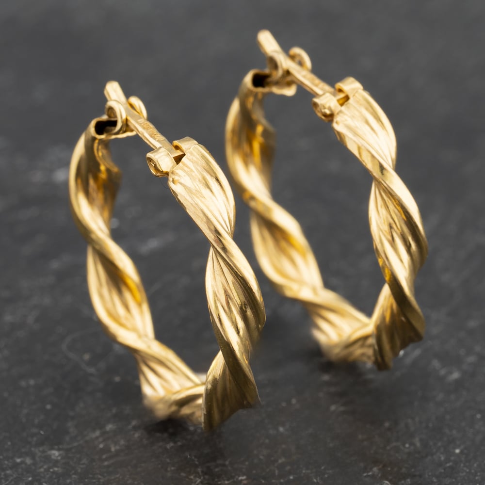 Click to view product details and reviews for Pre Owned Yellow Gold 20mm Twist Hoop Earrings 41173512.