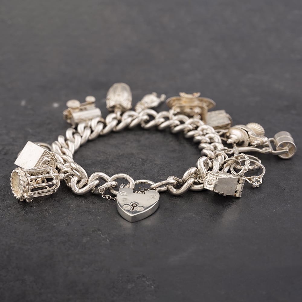Product photograph of Pre-owned Vintage Silver 12 Assorted Charms 7 25 Inch Charm Bracelet 41251371 from The Jewel Hut