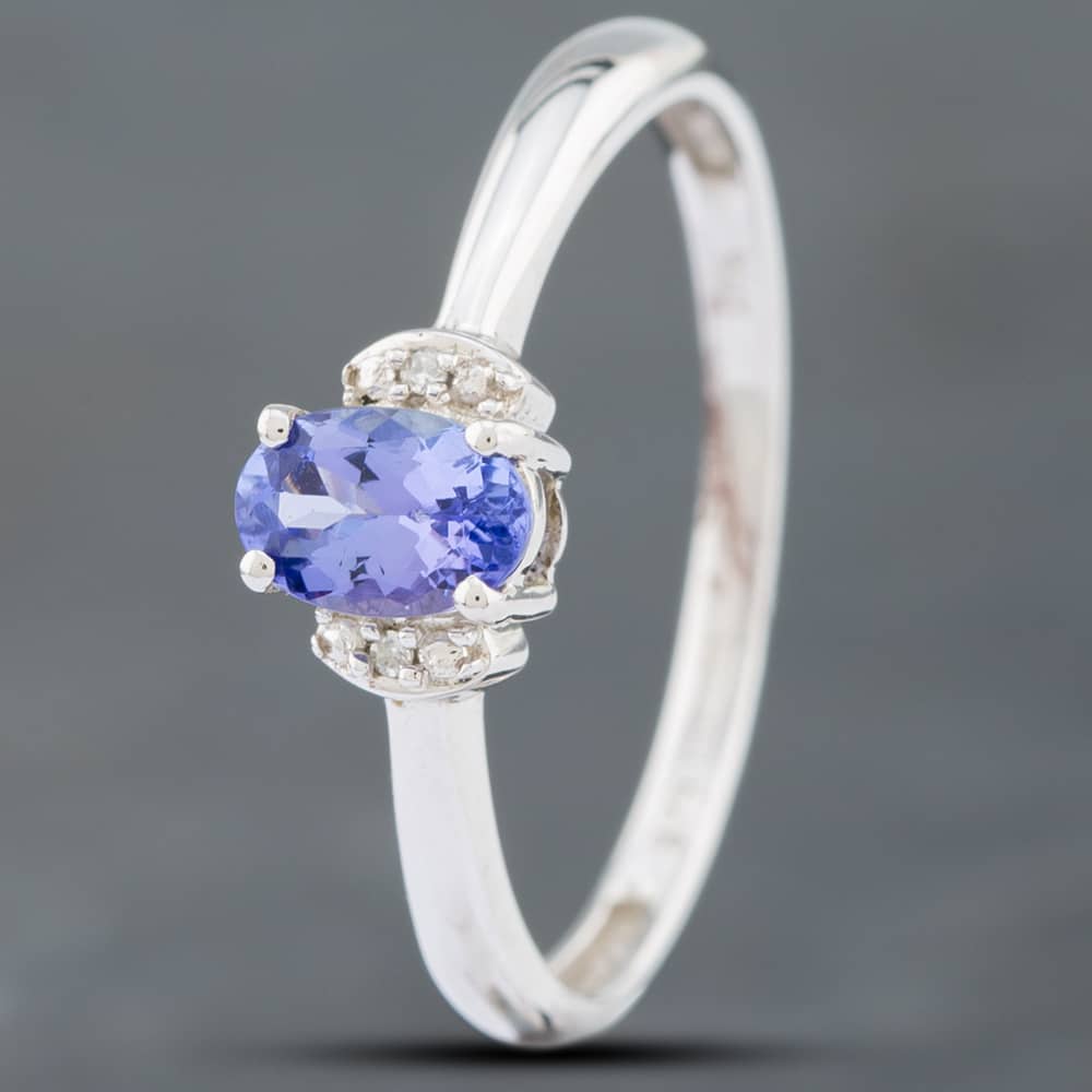 Product photograph of Pre-owned 9ct White Gold 0 45ct Oval Cut Tanzanite Amp 0 01ct Single Cut Diamond Cluster Ring 41381871 from The Jewel Hut