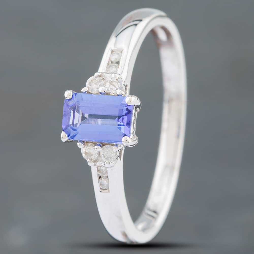 Product photograph of Pre-owned 9ct White Gold 0 56ct Emerald Cut Tanzanite Amp 0 09ct Single Cut Diamond Dress Ring 41381880 from The Jewel Hut