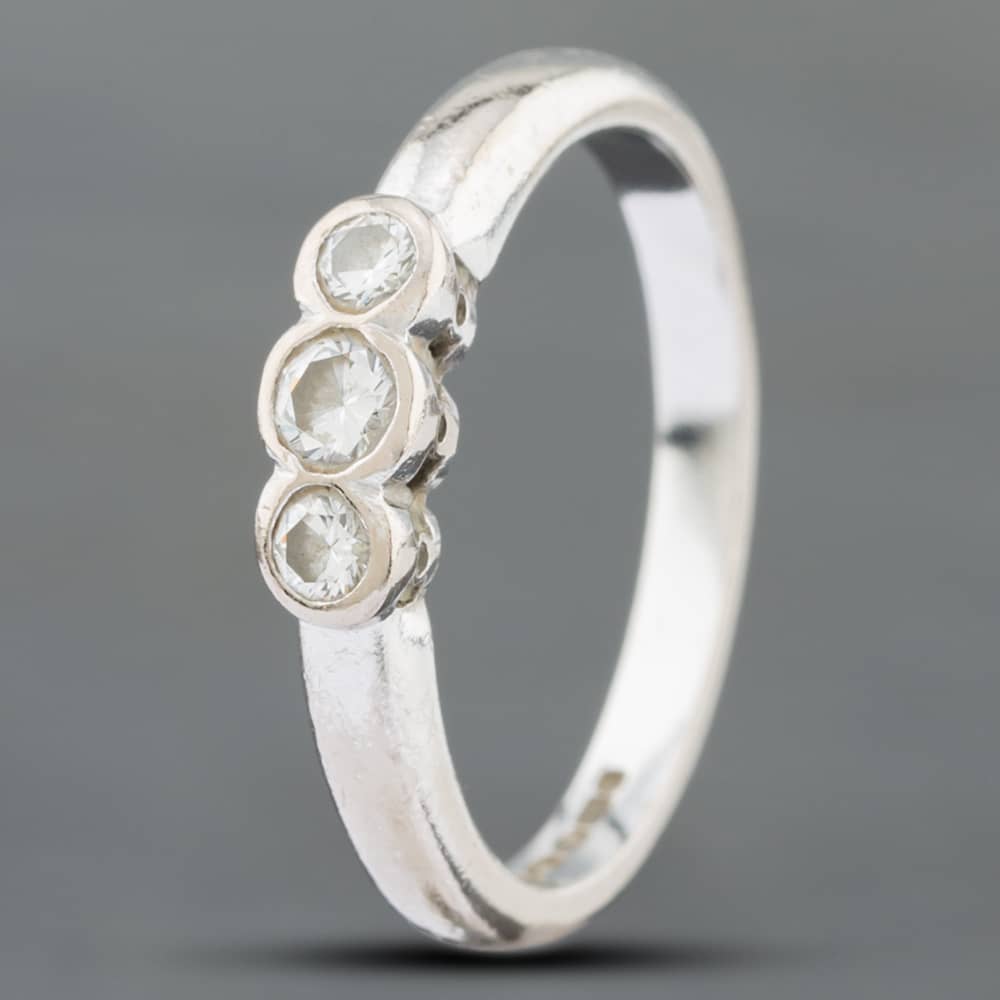 Product photograph of Pre-owned 18ct White Gold Brilliant Cut Diamond Rubover Three Stone Ring 41381995 from The Jewel Hut