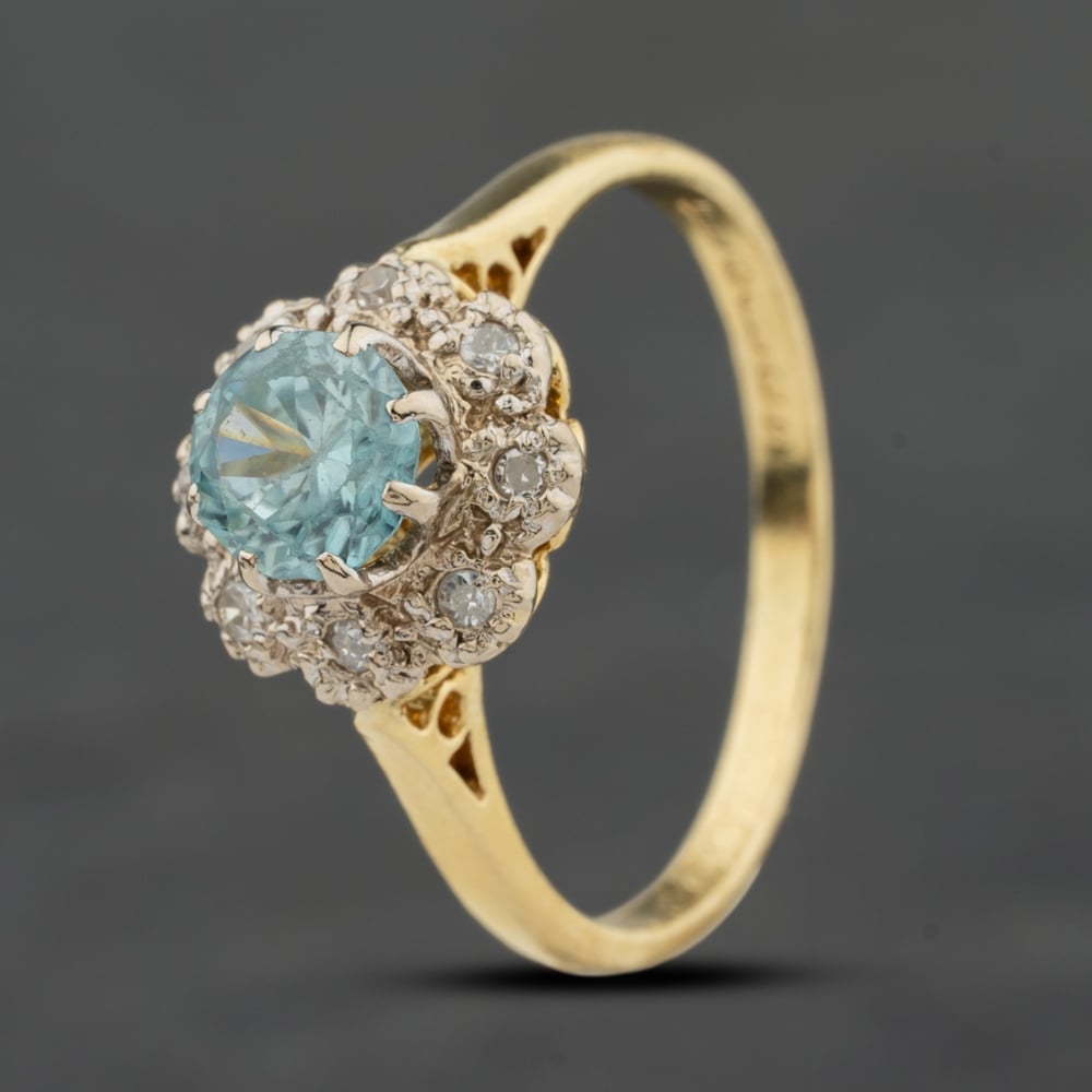 Click to view product details and reviews for Pre Owned Vintage 18ct Yellow Gold Blue Zircon And 008ct Diamond Oval Cluster Ring 41384018.