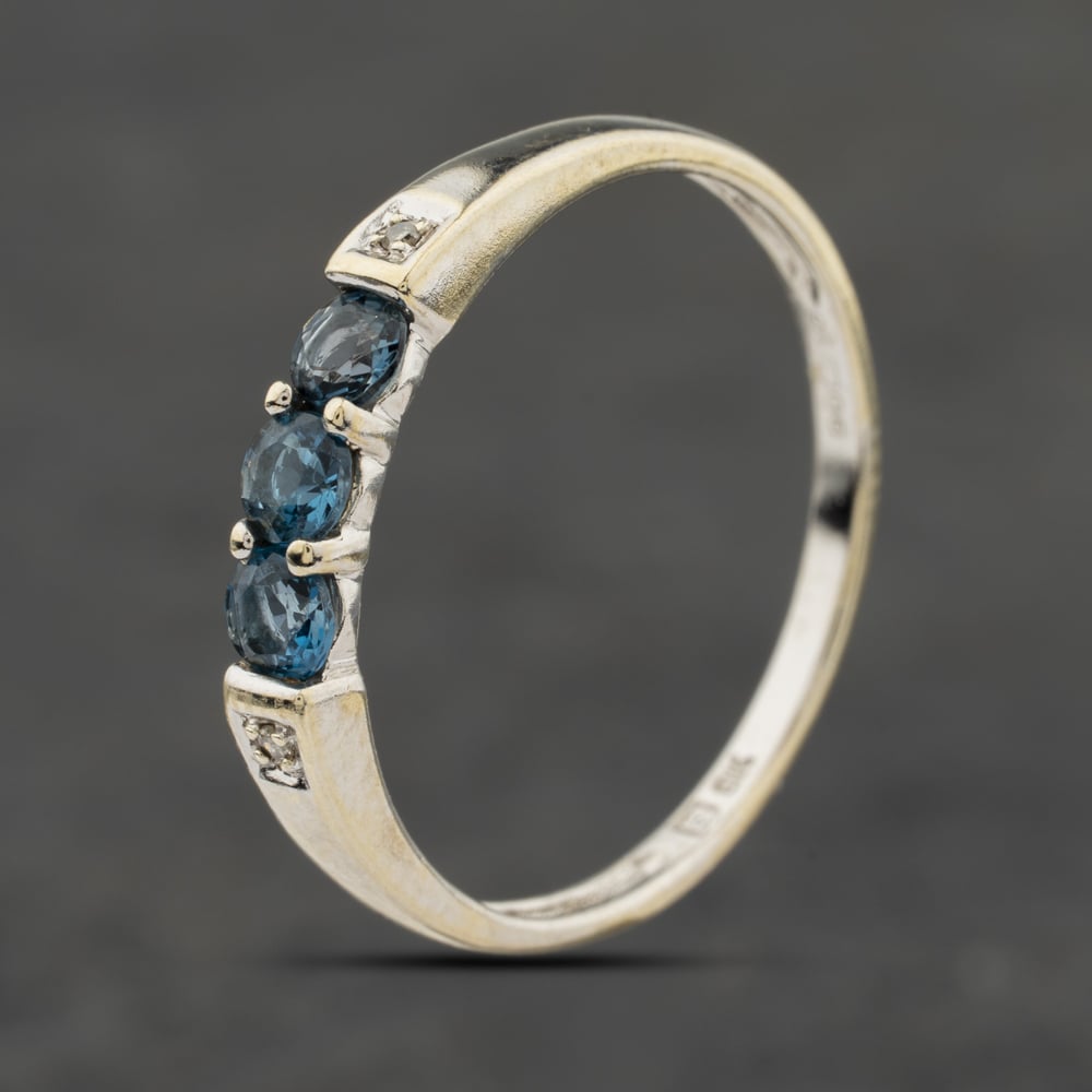 Click to view product details and reviews for Pre Owned 9ct White Gold Blue Topaz And 002ct Diamond Five Stone Ring 41384045.