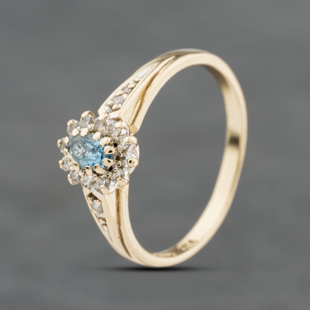 Click to view product details and reviews for Pre Owned 9ct Yellow Gold Blue Topaz And 015ct Brilliant Cut Diamond Oval Cluster Ring 41384136.