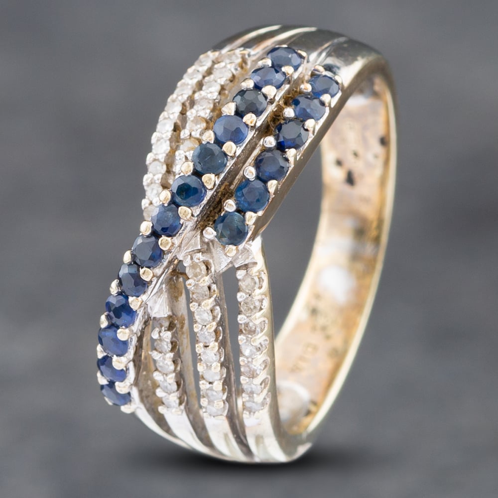 Product photograph of Pre-owned 9ct Yellow Gold Sapphire Amp Brilliant Cut Diamond Crossover Ring 41481641 from The Jewel Hut