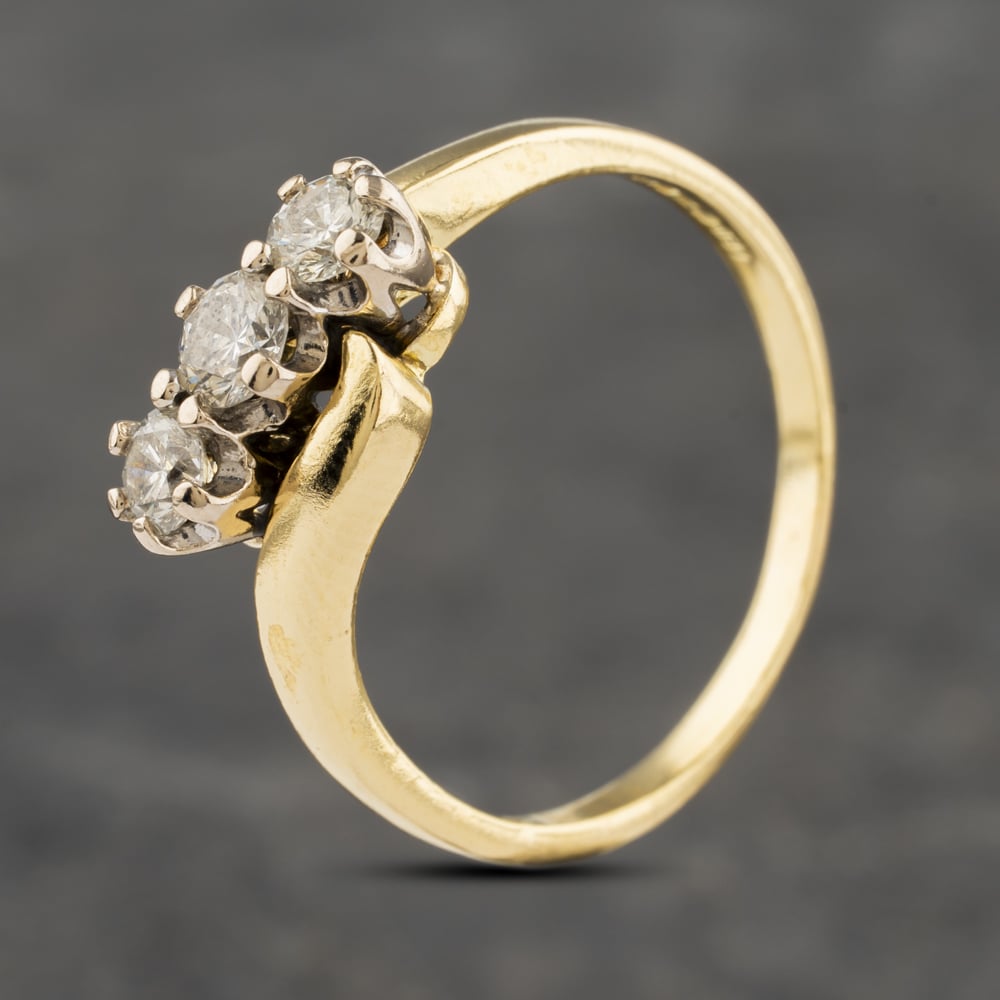 Click to view product details and reviews for Pre Owned 18ct Yellow Gold 050ct Brilliant Cut Diamond Twist Three Stone Ring 41482052.