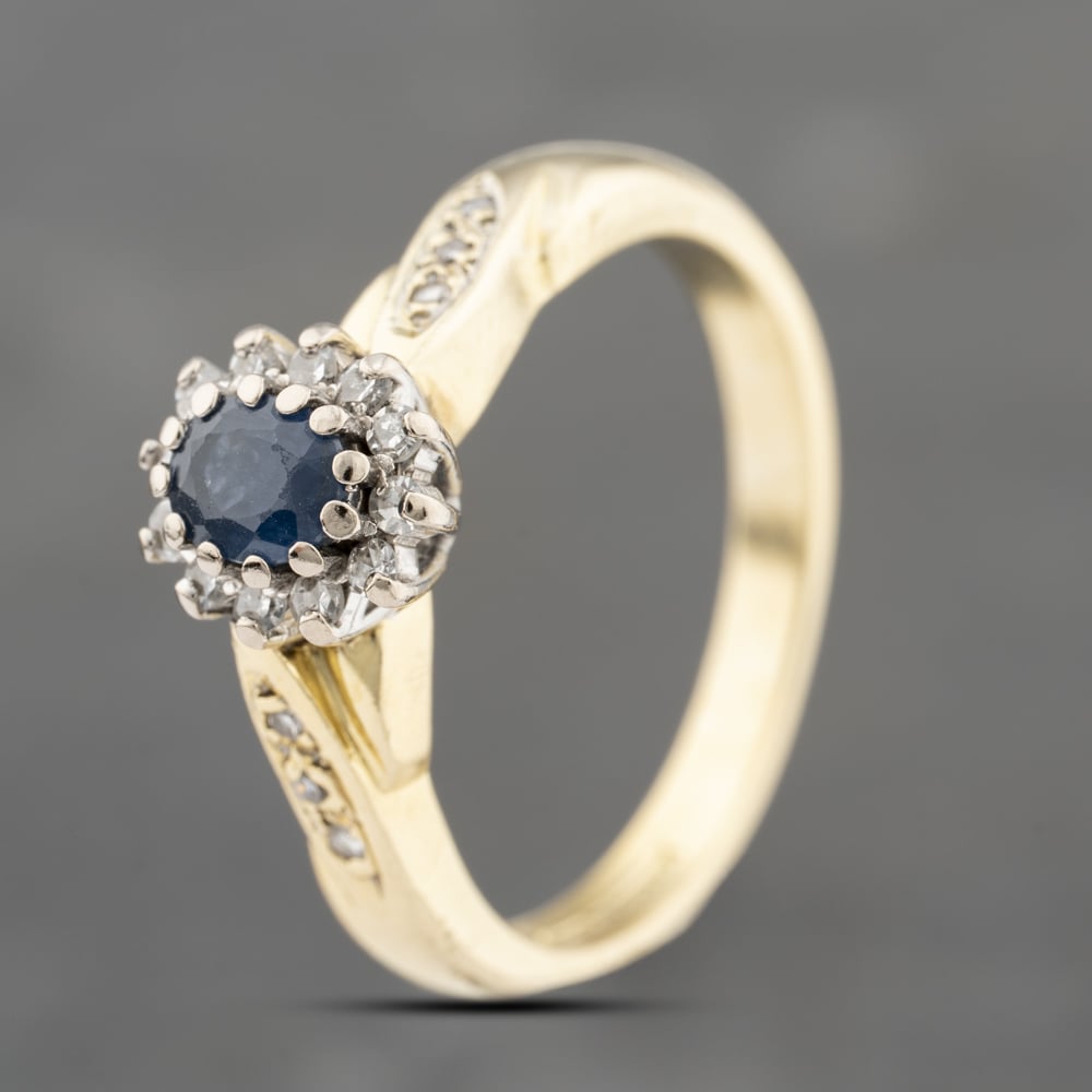 Click to view product details and reviews for Pre Owned 18ct Yellow Gold Sapphire And Diamond With Diamond Shoulders Cluster Ring 41482327.