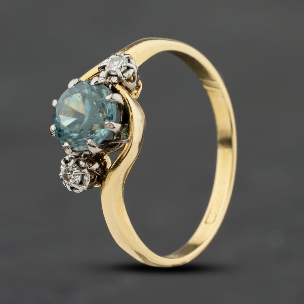 Click to view product details and reviews for Pre Owned Vintage Yellow Gold Blue Zircon And 006ct Brilliant Cut Diamond Twist Three Stone Ring 41482516.