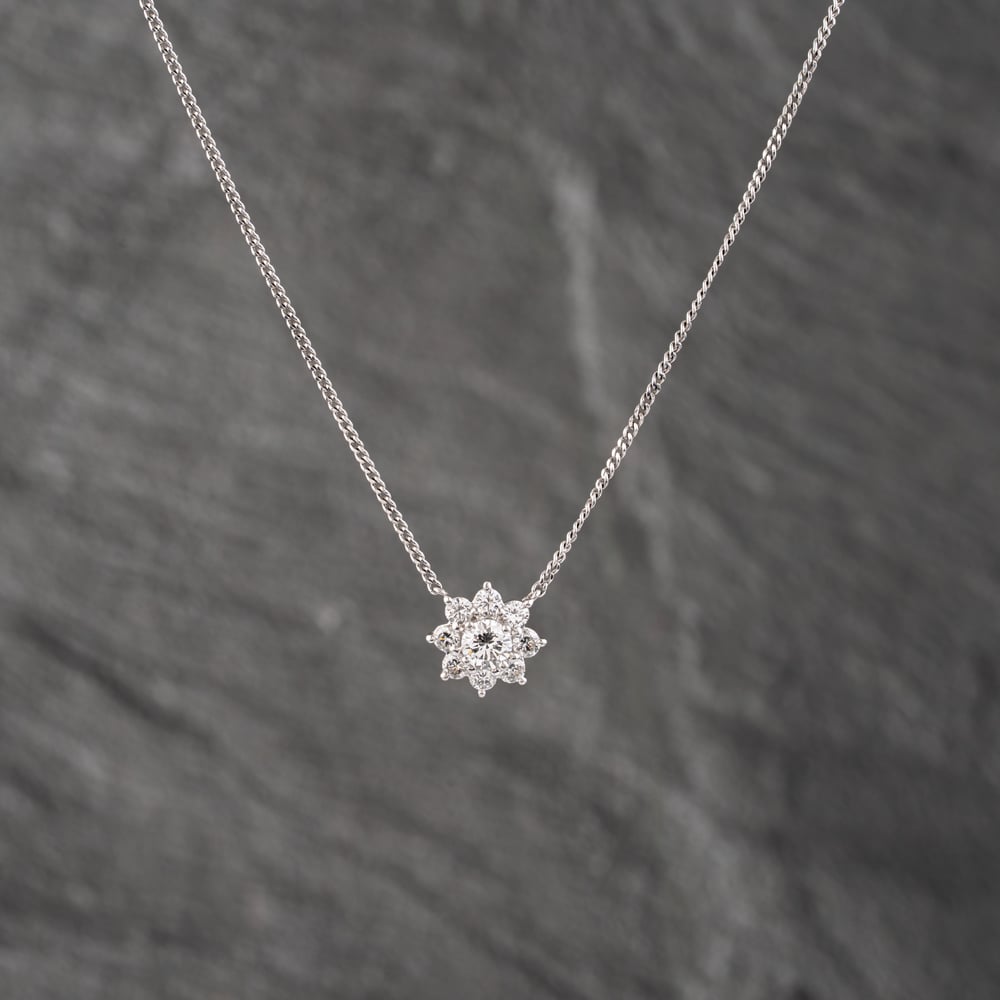 Click to view product details and reviews for Pre Owned Platinum 086ct Brilliant Cut Diamond Flower Cluster Pendant And 16 Inch Curb Chain 43141244.
