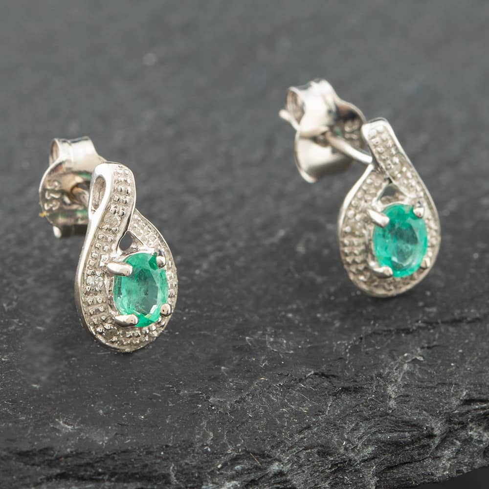 Product photograph of Pre-owned White Gold 0 30ct Oval Cut Emerald Amp 0 03ct Diamond Swirl Stud Earrings 43171090 from The Jewel Hut