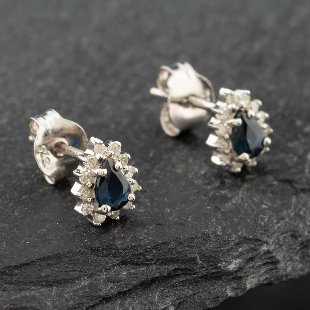 Product photograph of Pre-owned White Gold 0 38ct Pear Cut Sapphire Amp 0 09ct Brilliant Cut Diamond Cluster Stud Earrings 43171094 from The Jewel Hut