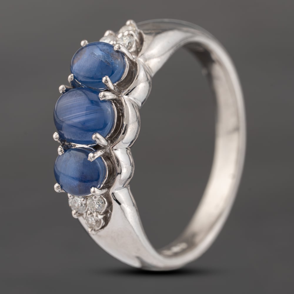 Click to view product details and reviews for Pre Owned Platinum 250ct Cabouchon Cut Star Sapphire And 013ct Diamond Three Stone Ring 43361158.