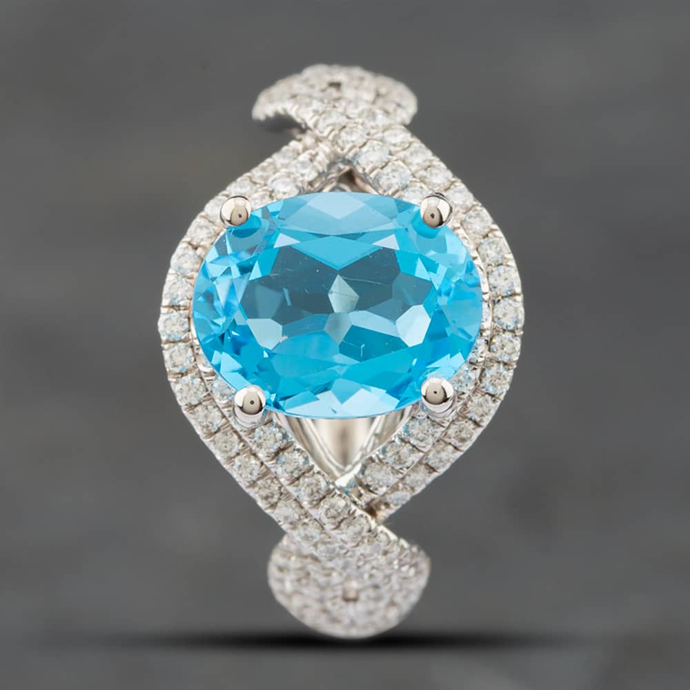 Pre-Owned 14ct White Gold Oval Cut Blue Topaz & Single Cut Diamond Crossover Ring 43451006
