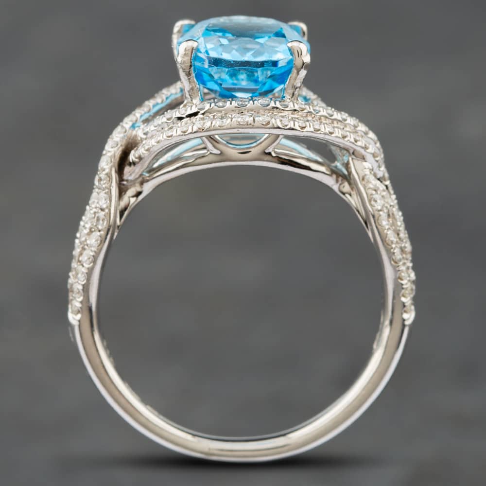 Pre-Owned 14ct White Gold Oval Cut Blue Topaz & Single Cut Diamond Crossover Ring 43451006