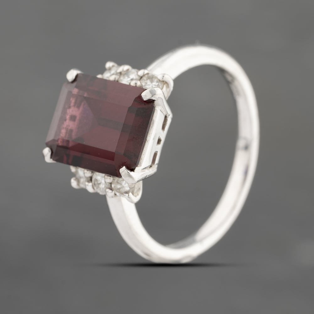 Click to view product details and reviews for Pre Owned Platinum Garnet And 020ct Brilliant Cut Diamond Rectangular Dress Ring 43471005.