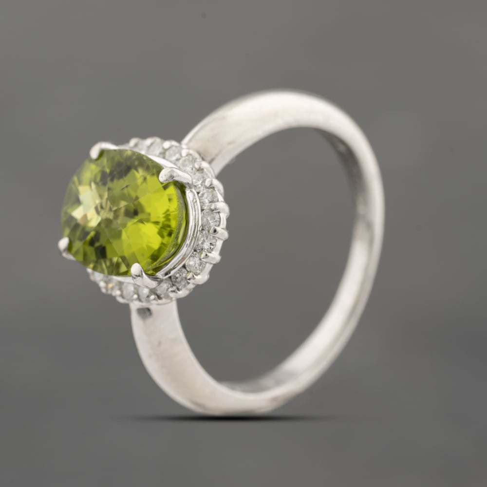Click to view product details and reviews for Pre Owned Platinum 301ct Peridot And 028ct Diamond Oval Cluster Ring 43541005.