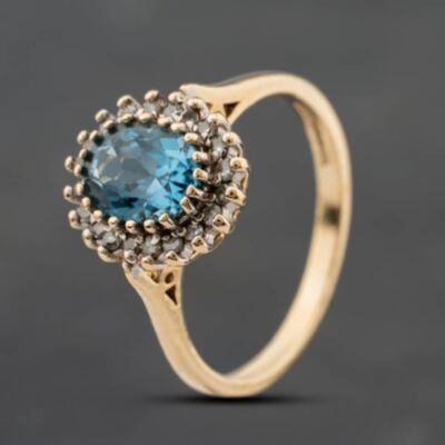 Pre-Owned 9ct Yellow Gold Blue Topaz & 0.20ct Diamond Oval Cluster Ring 41384903