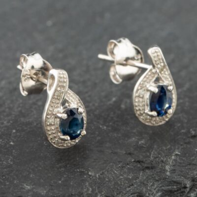 Pre-Owned White Gold 0.43ct Oval Cut Sapphire & 0.03ct Diamond Swirl Stud Earrings 43171088