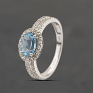 Pre-Owned 9ct White Gold Blue Topaz & 0.20ct Brilliant Cut Diamond Oval Dress Ring 41383390