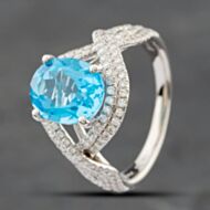 Pre-Owned 14ct White Gold Oval Cut Blue Topaz & Single Cut Diamond Crossover Ring 43451006