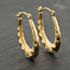 Pre-Owned Yellow Gold 25.5mm Oval Patterned Creole Earrings 41173932